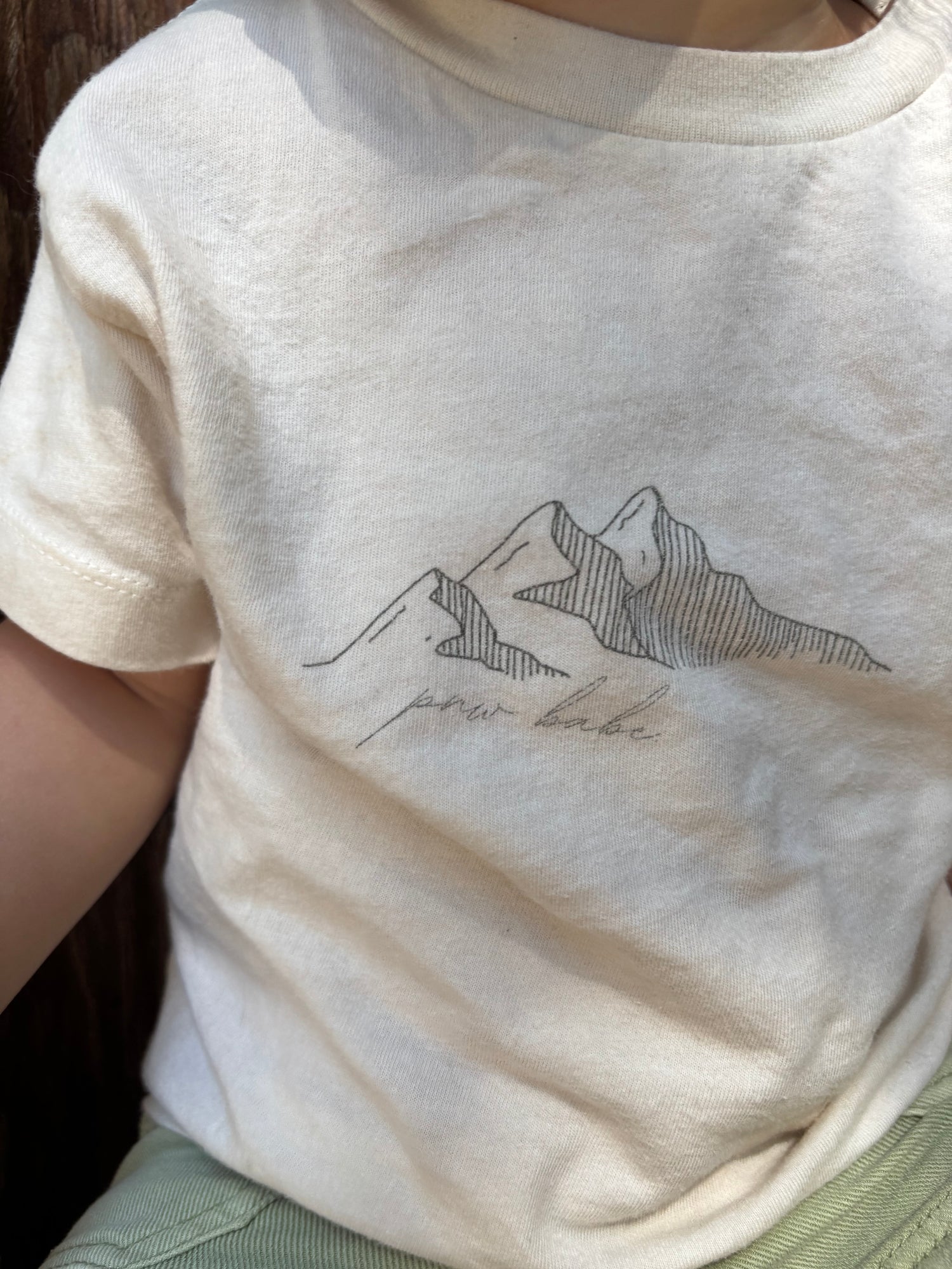 Close up of a toddler tshirt that says PNW babe
